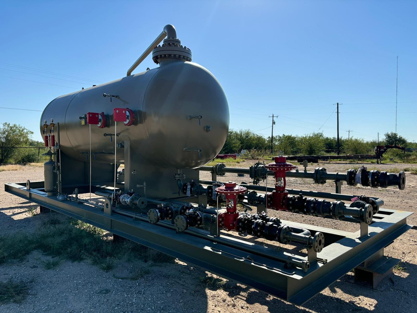 New separator skid with red control valves in morning light